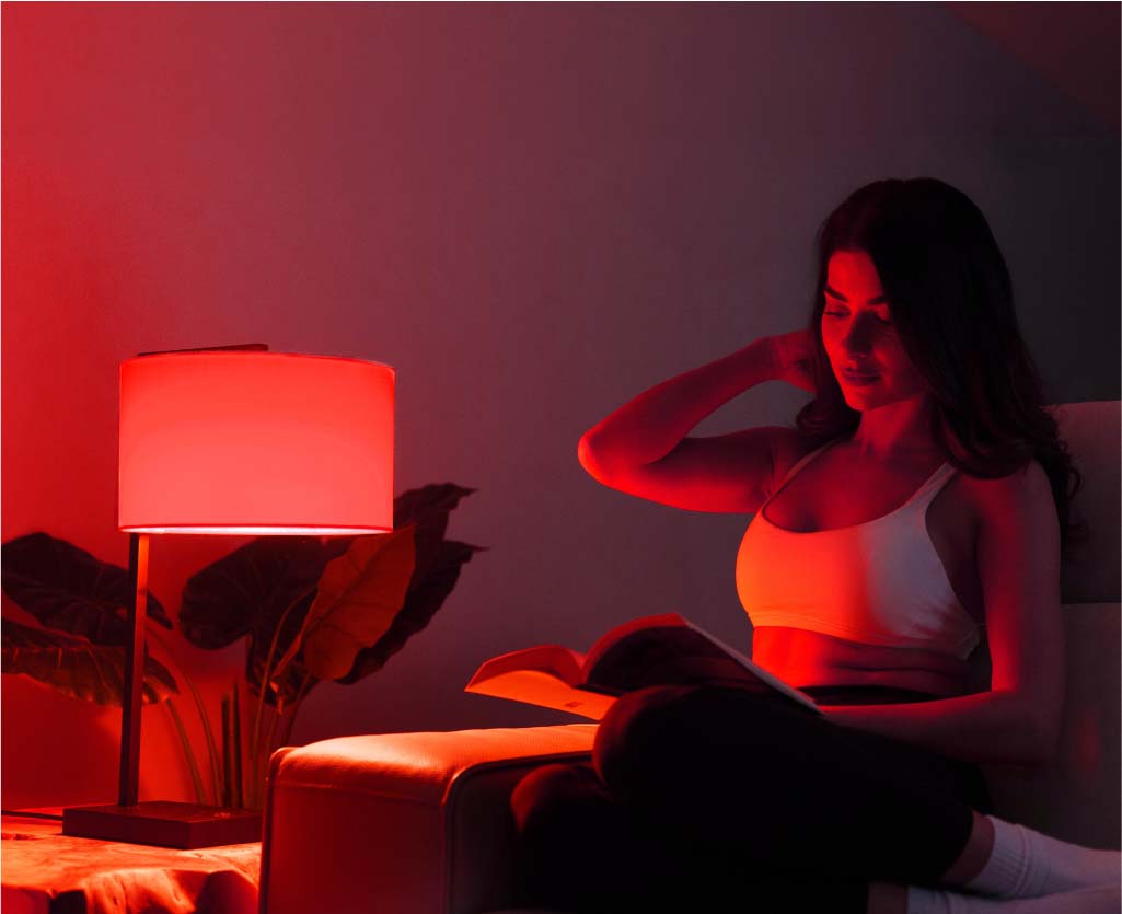 Woman Sitting On Sofa Next To Lamp Glowing Red