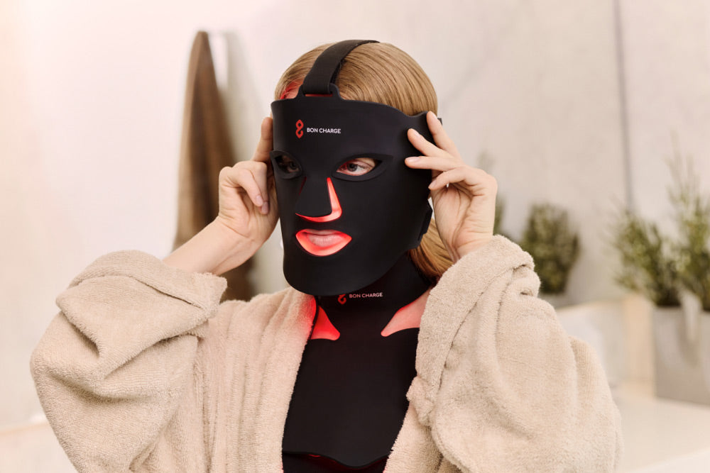 Woman Wearing Red Light Face Mask and a Neck and Chest Mask